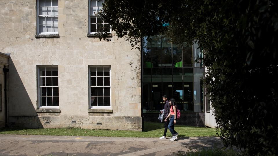 Two students walking side-by-side together on Ruskin College campus.