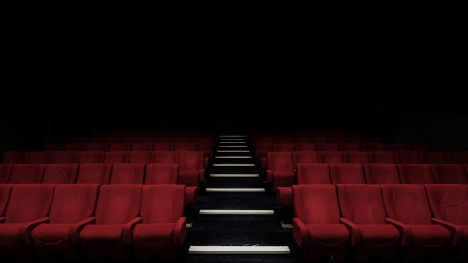 Rows of red seats in a cinema.