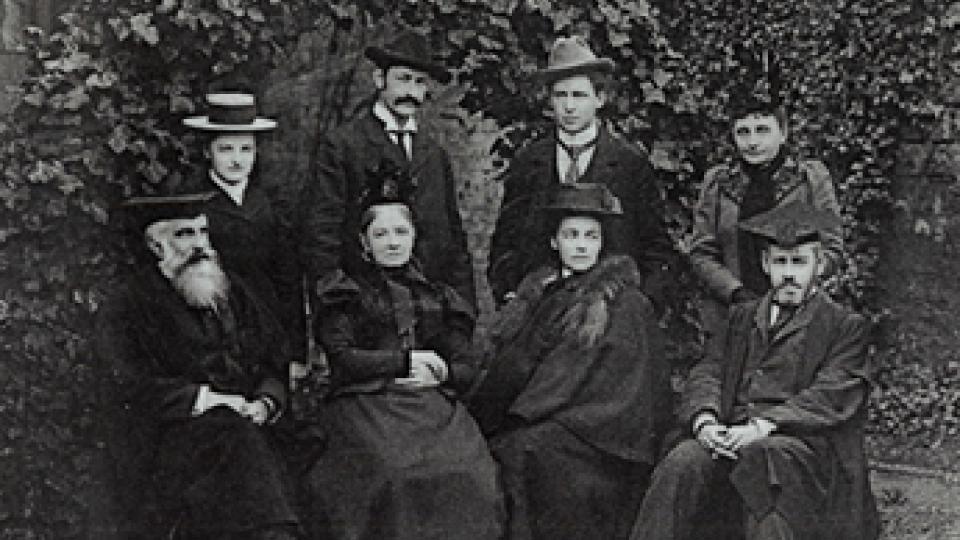 Americans Charles Beard and Walter Vrooman with six others sat in a garden during 1899.