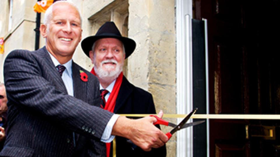 Ruskin headquarters opened by Gordon Marsden MP, cutting a ribbon with scissors.