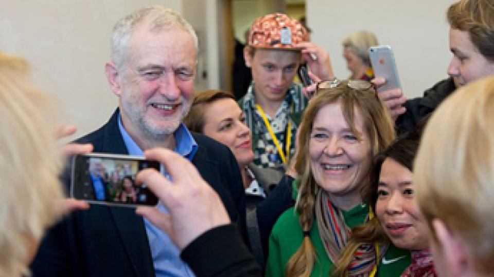 Jeremy Corbyn is pictured with members of the public, smiling at a phone camera.