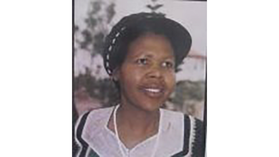 Nomvuyo (Vuyo) Ngwaxaxa is wearing a black hat and black and white dress.